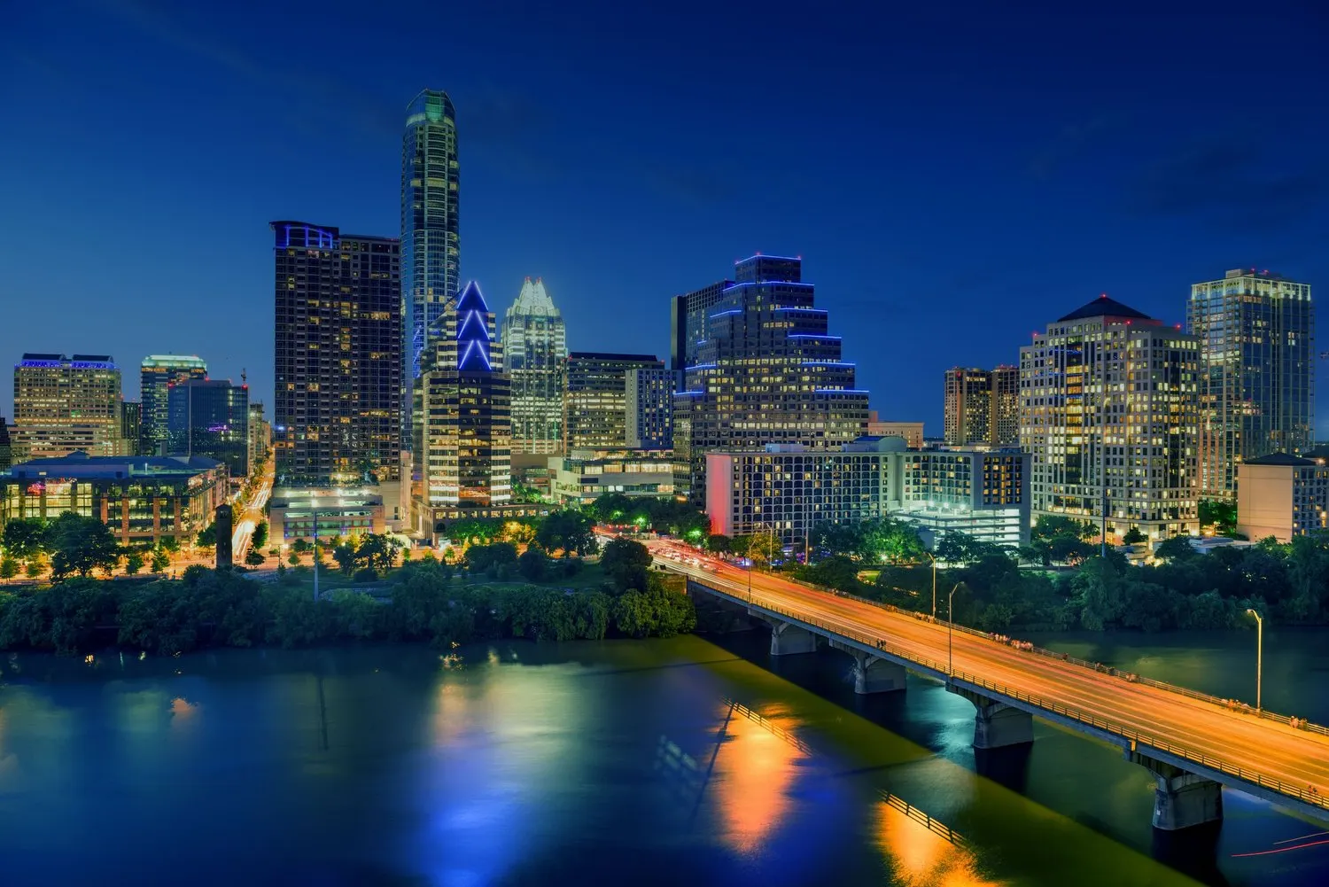 Downtown Austin skyline at night, seen across Lady Bird Lake