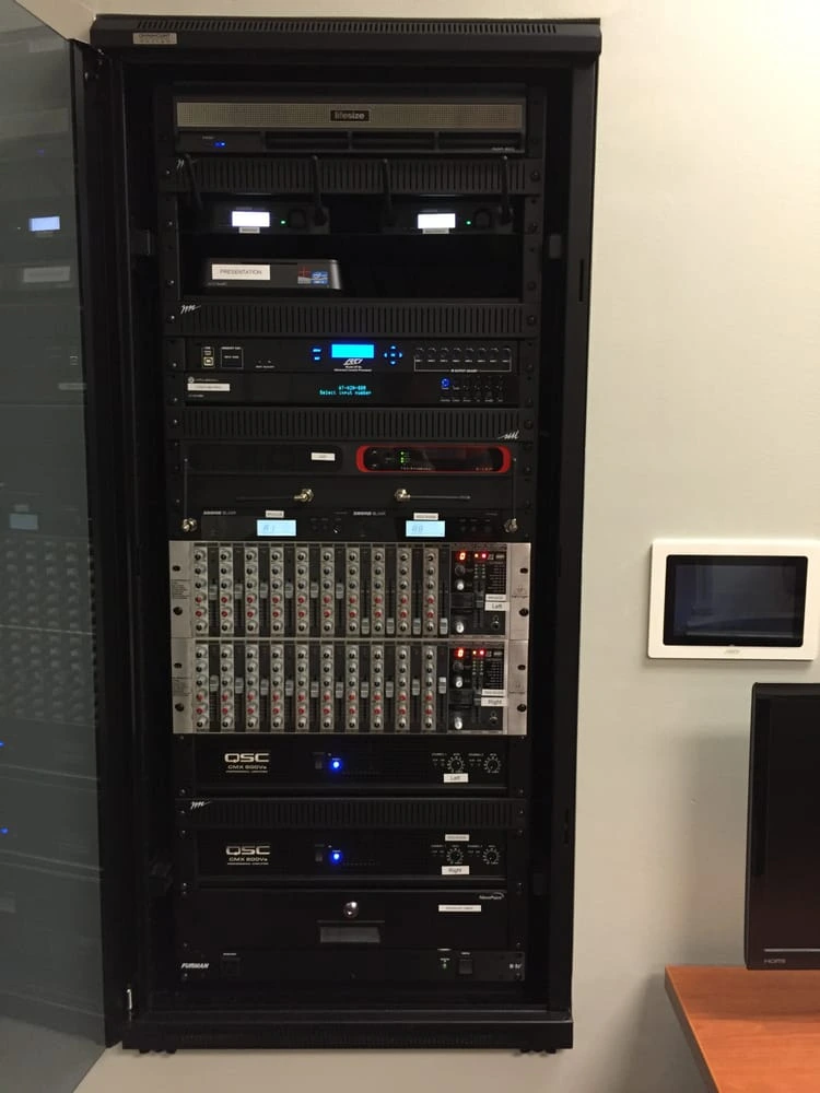 Commercial audio equipment rack with amplifiers and signal processing