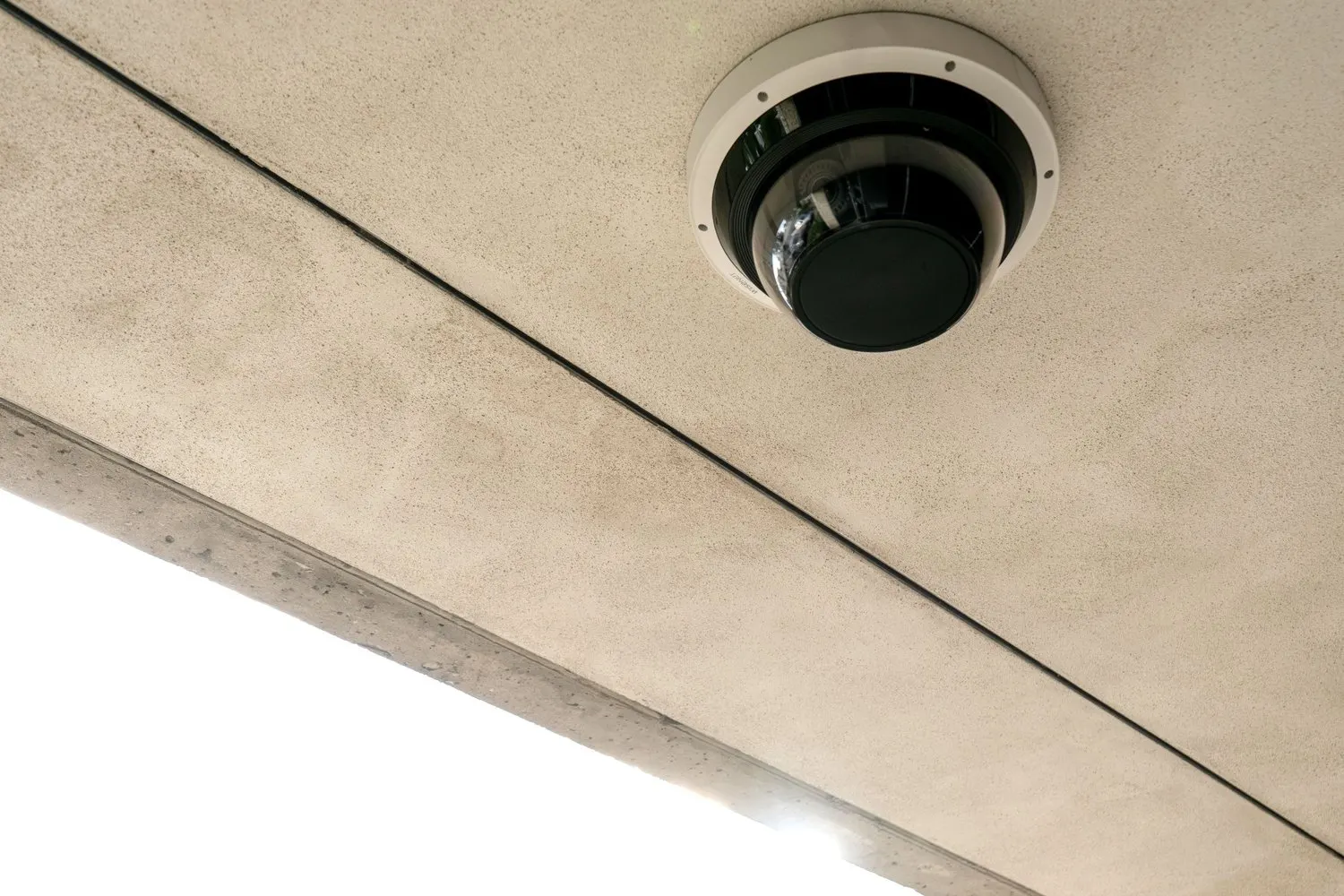 Dome security camera mounted on a concrete ceiling