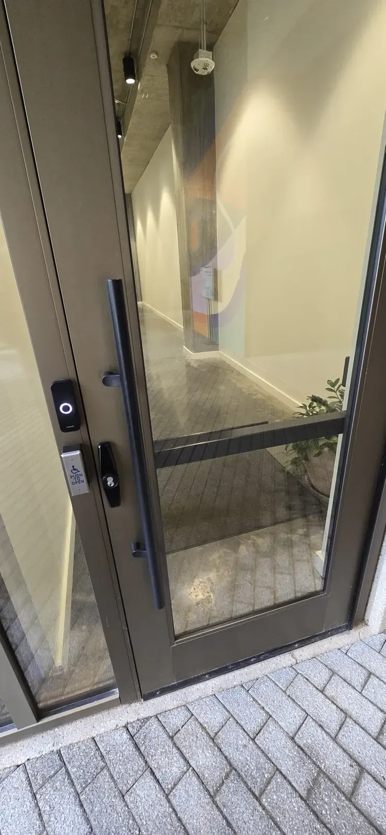 Openpath smartphone access control reader installed at a commercial office door
